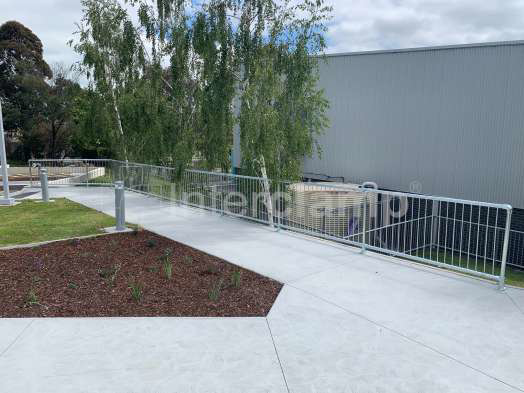 Safety balustrade at a primary school constructed from Interclamp pedestrian barriers and tube clamp fittings, ensuring a secure environment for children.